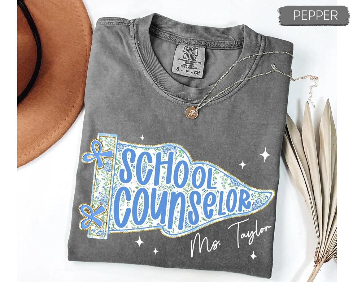 Custom School Counselor T-shirt, Personalized Floral Pennant Flag Graphic, Blue Wildflower Stars Design, Comfort Colors Retro Tee, Counselor Appreciation Gift, Custom Name